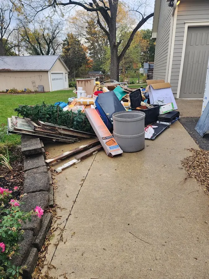Dumpster being loaded with debris for Estate Cleanout Dumpster Rental in Vermillion
